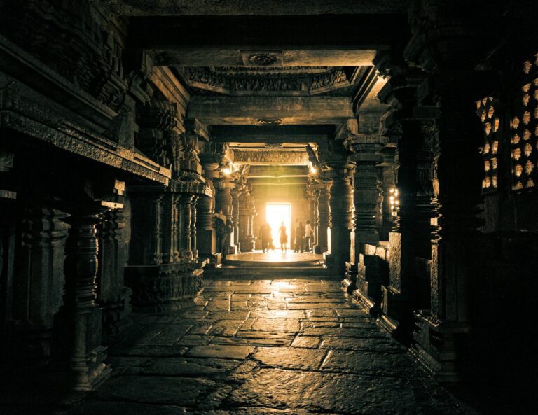 Sunlight streaming through an ancient stone temple corridor