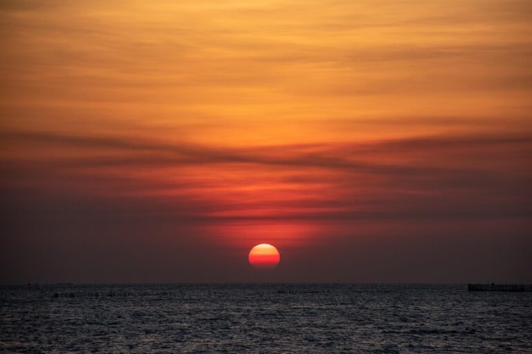 Dusky red and orange sky over the ocean at twilight