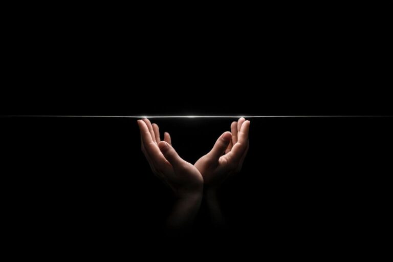 Open hands emerging from obsidian darkness catching a thread of silver light