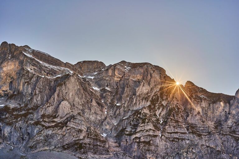Sunrise light over a rugged mountain cliff landscape