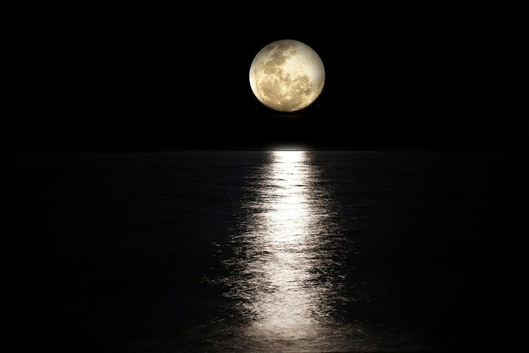 Full moon reflecting over a calm dark sea